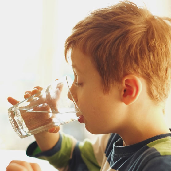 Child drinking water from glass